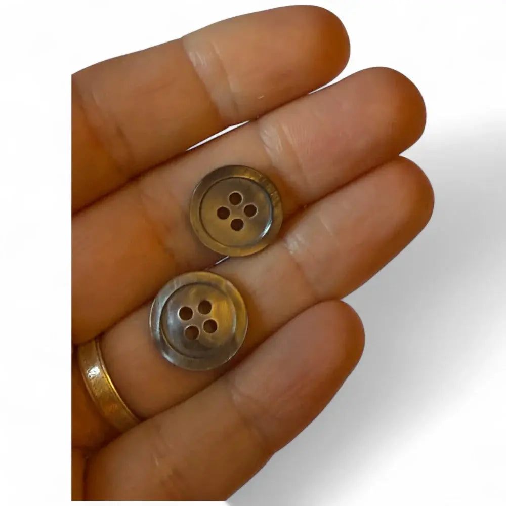 Two iridescent four-hole buttons.