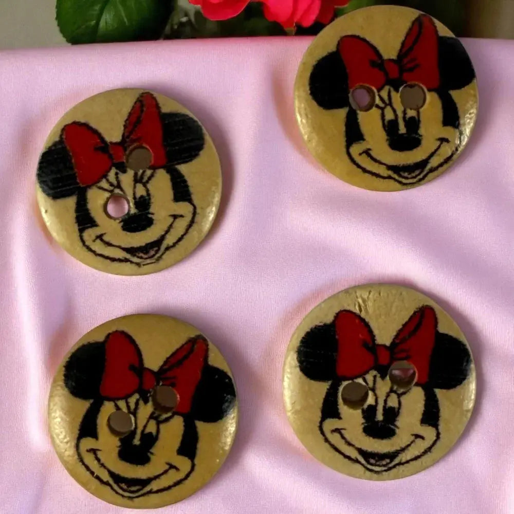 Four Minnie Mouse wooden buttons.