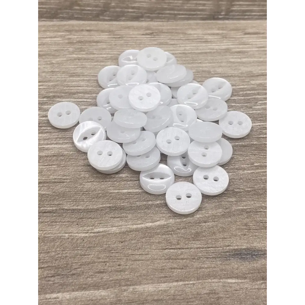Pile of white, two-hole buttons.