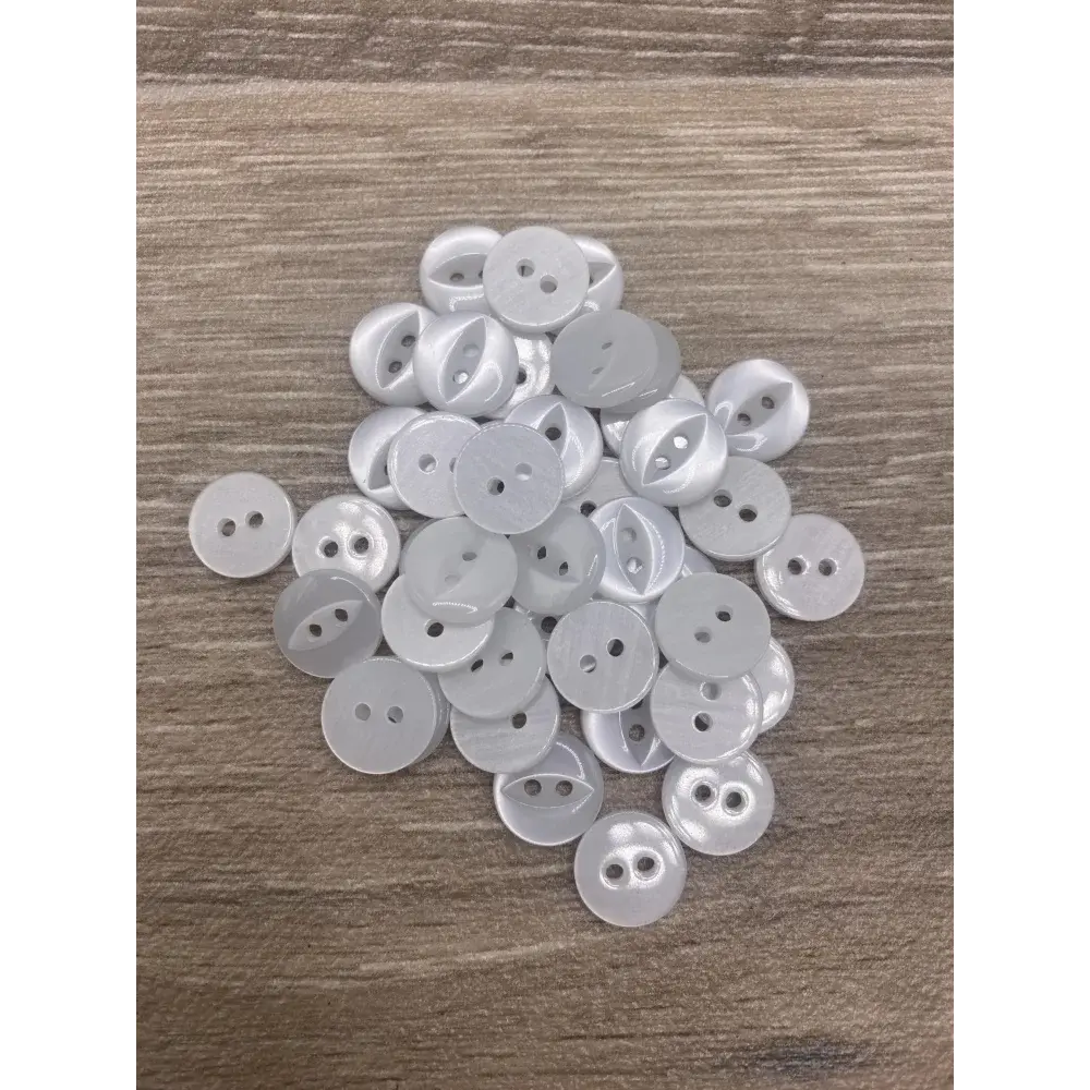Pile of white two-hole buttons.