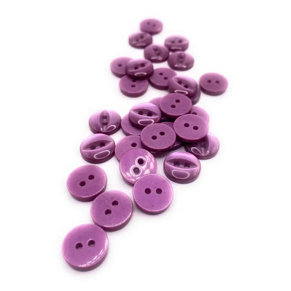 Pile of purple sewing buttons.