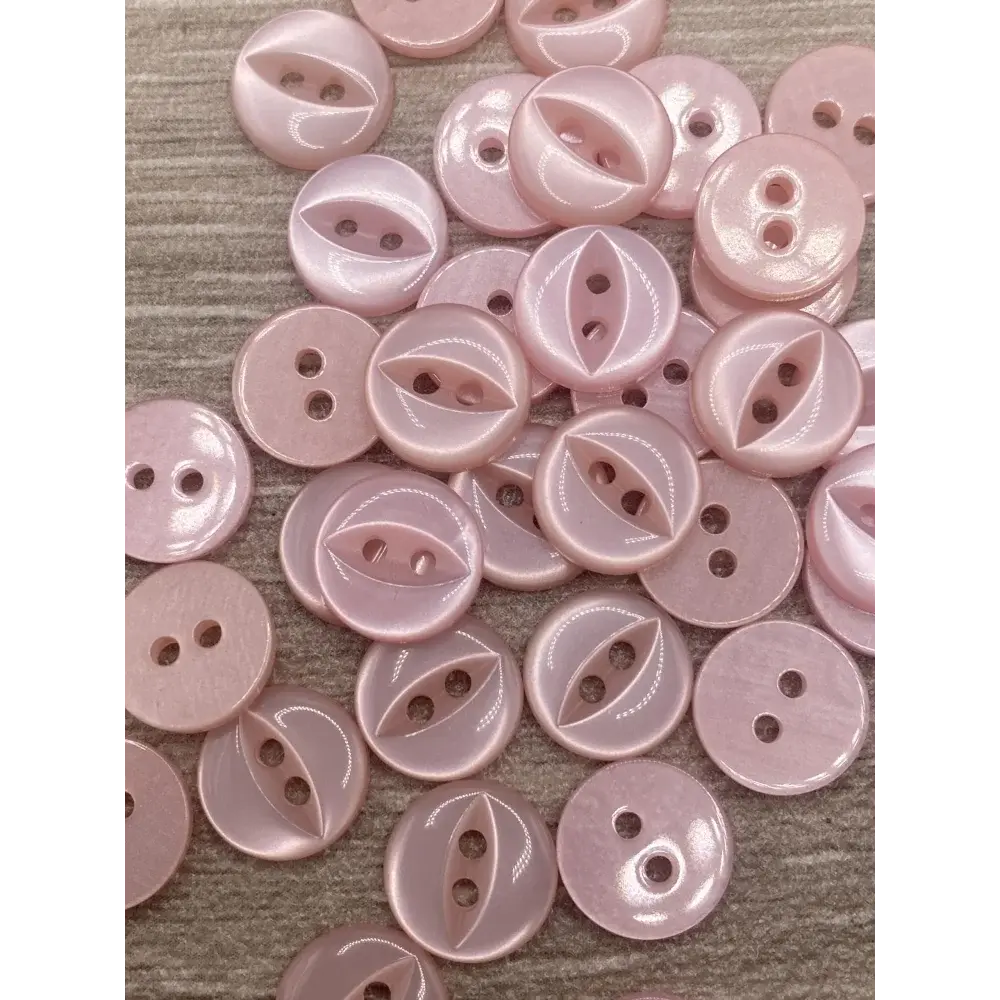 Pile of pink two-hole buttons.