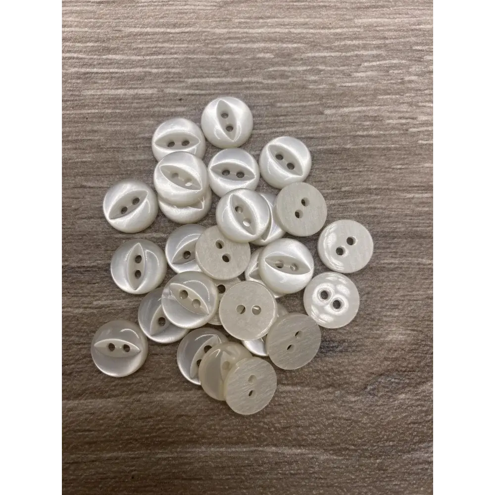 Pile of white, round buttons.