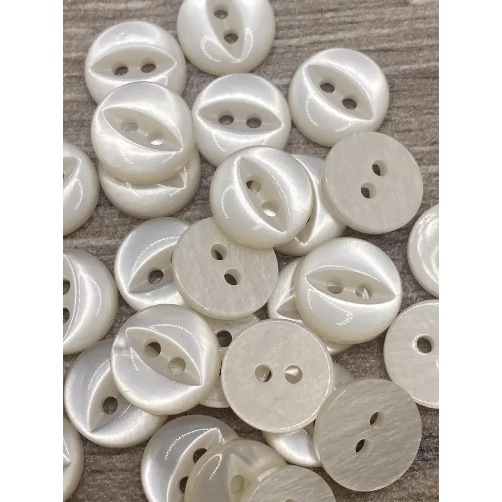 Pile of white, two-hole buttons.