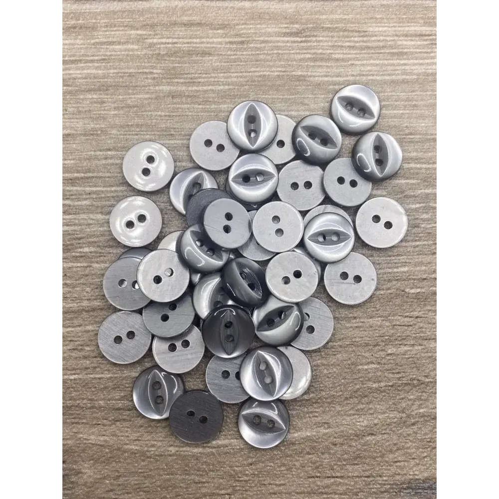 Pile of gray two-hole buttons.