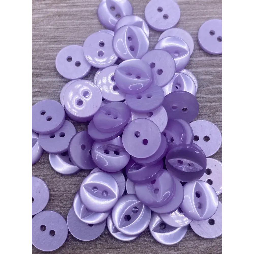 Pile of lavender two-hole buttons.