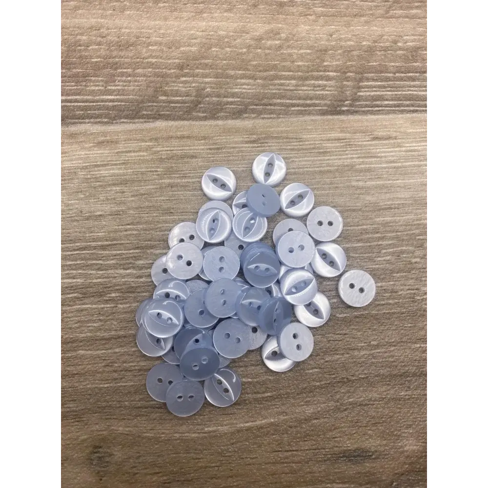 Pile of light blue buttons.