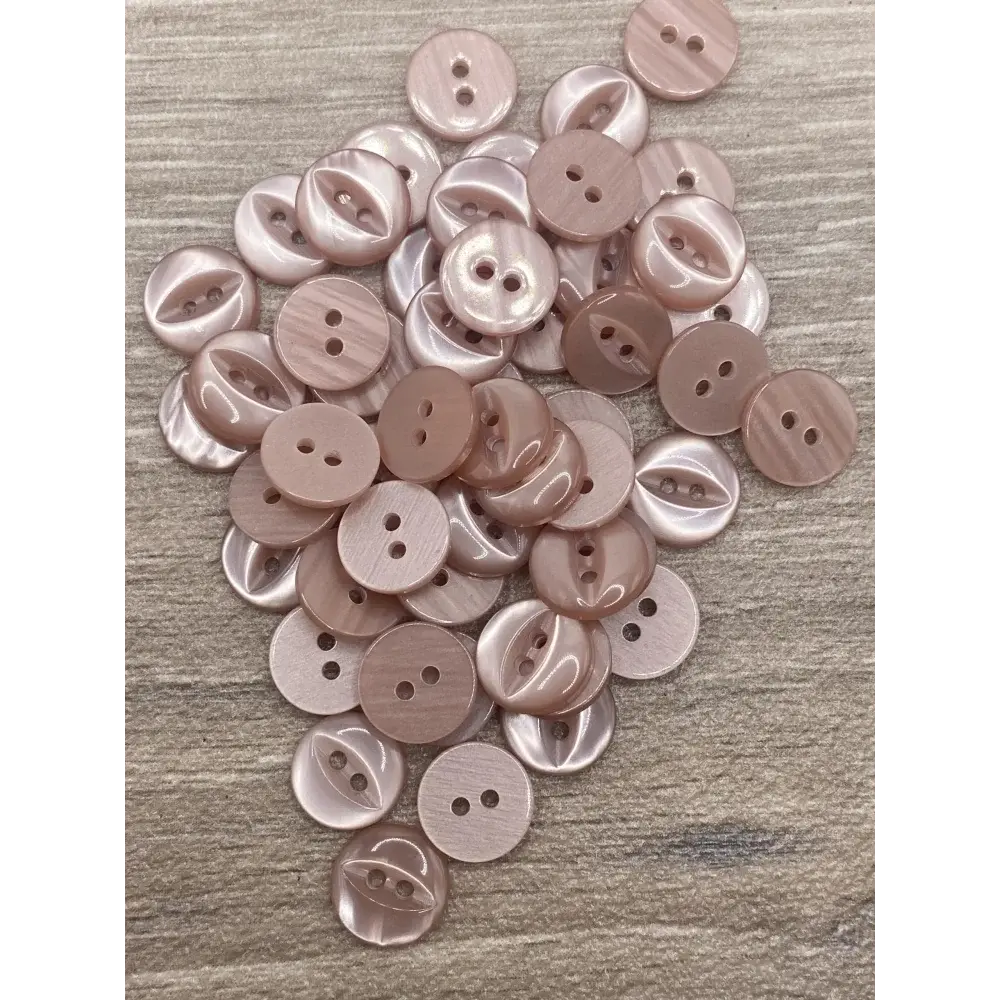 Pile of pink two-hole buttons.