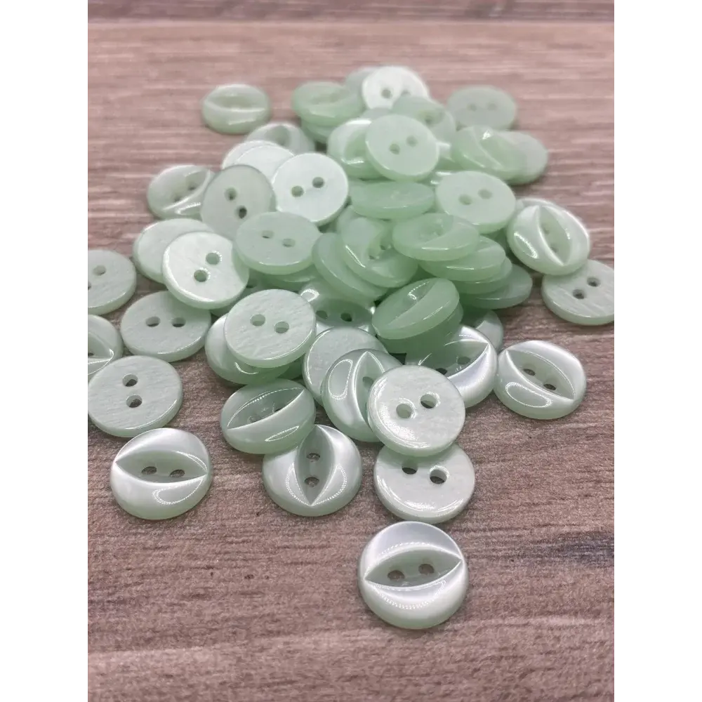 Pile of light green buttons.