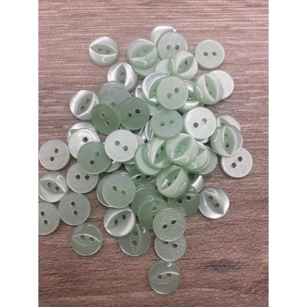 Pile of two-hole pale green buttons.