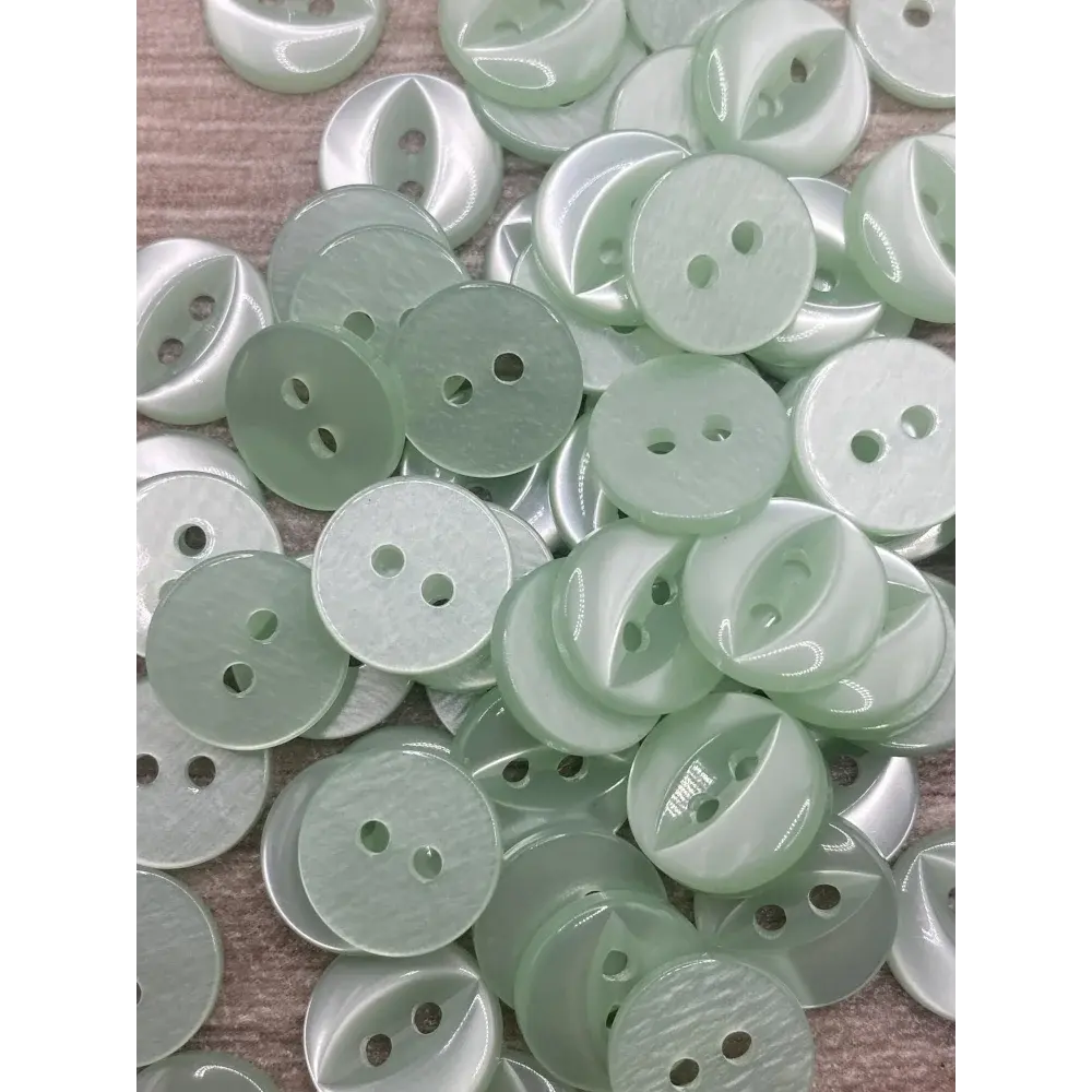 Pile of pale green two-hole buttons.