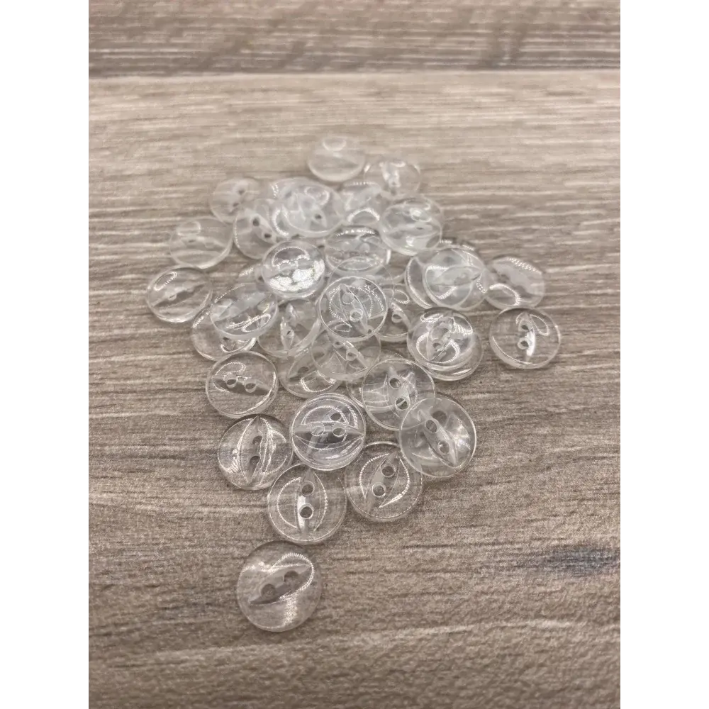 Pile of clear, two-hole buttons.
