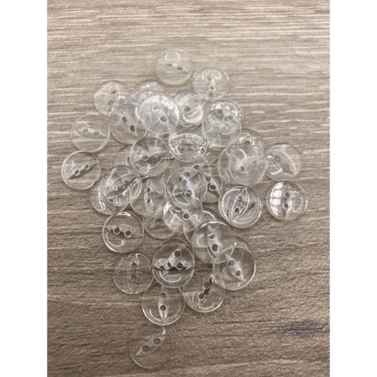 Pile of clear, two-hole buttons.