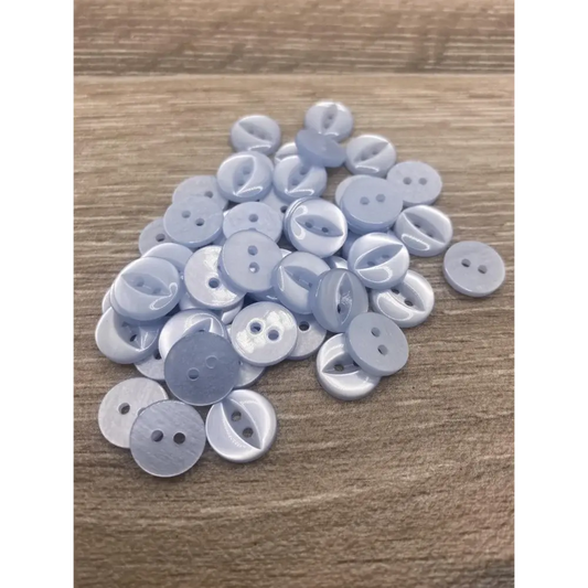 Pile of light blue buttons.