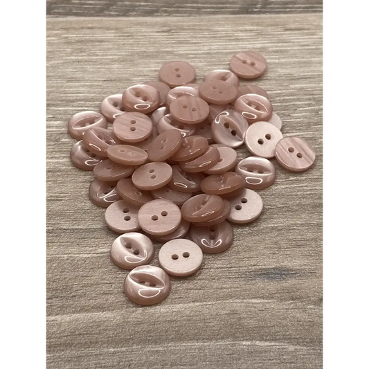 Pile of pink two-hole buttons.