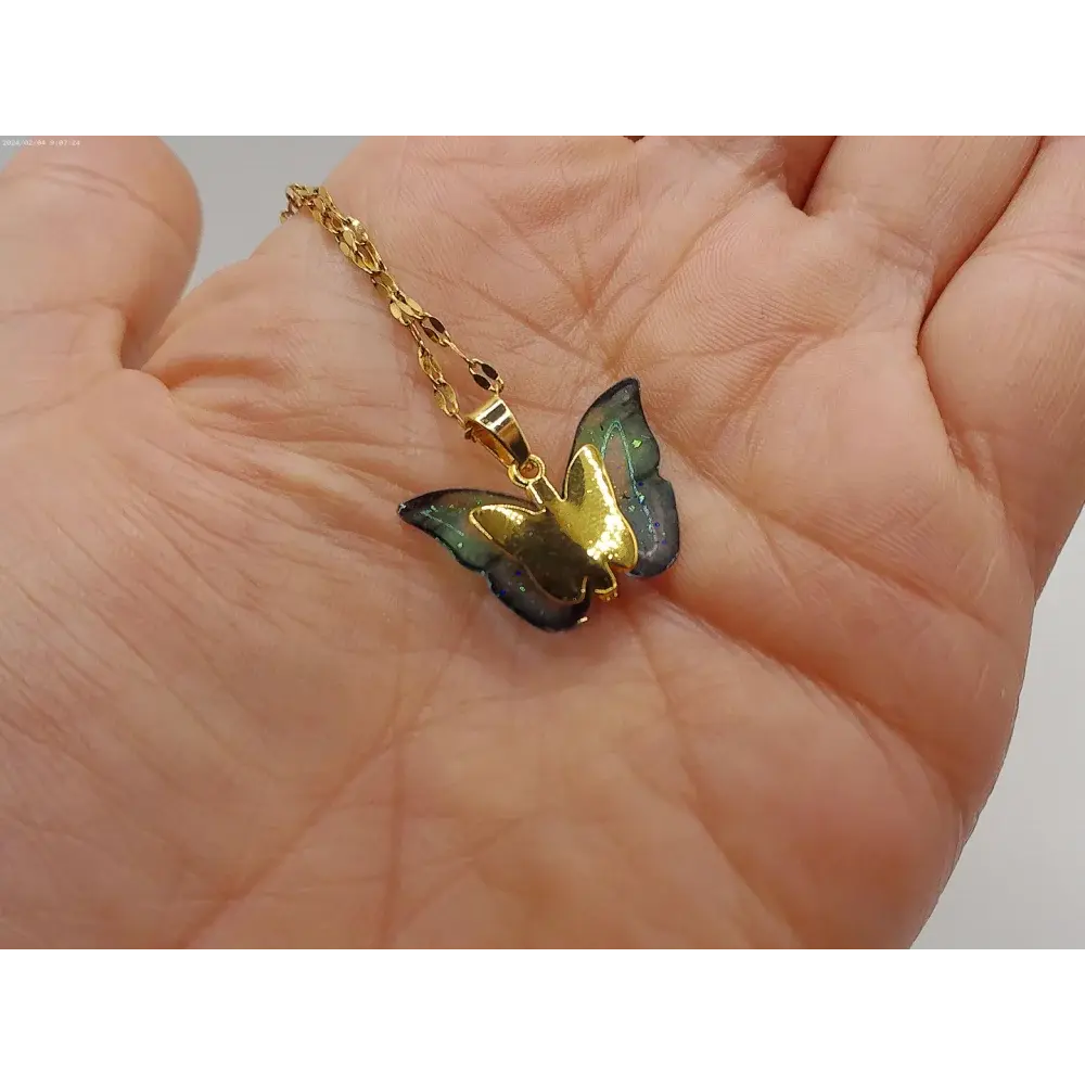 Gold butterfly pendant necklace.