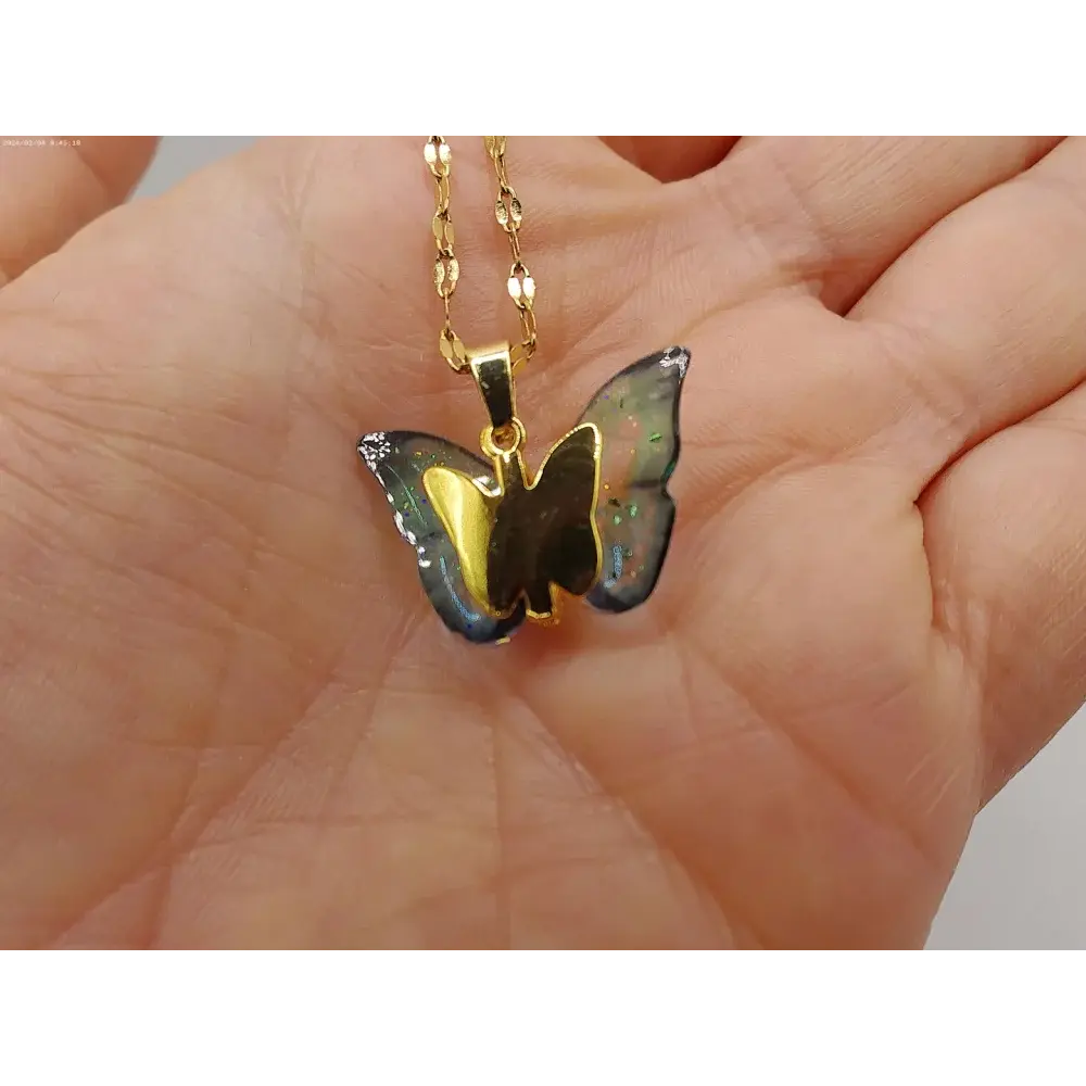 Gold butterfly pendant necklace.