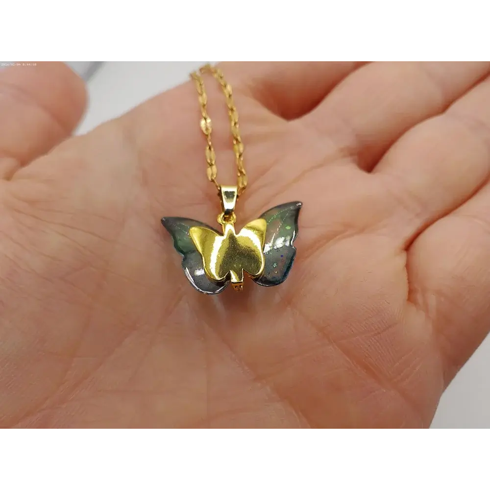 Gold butterfly pendant necklace.