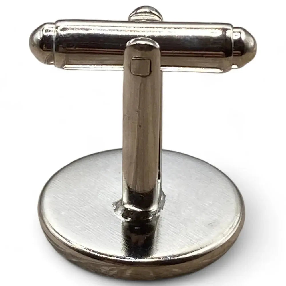 Silver-toned cufflink with toggle closure.