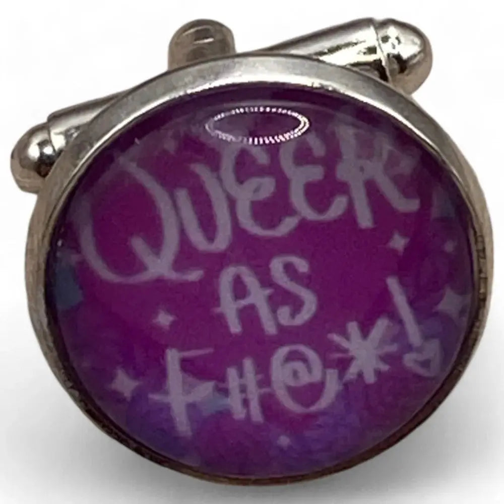 Cufflink with purple background.
