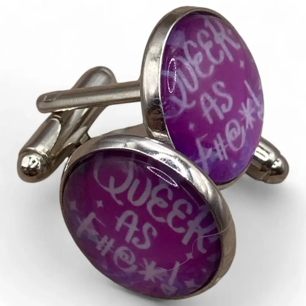 Silver cufflinks with purple ’Queer as F***’ design.