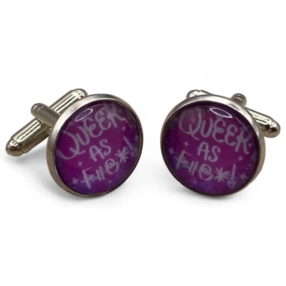 Pair of silver cufflinks with purple ’Queer as F#@*!’ design.