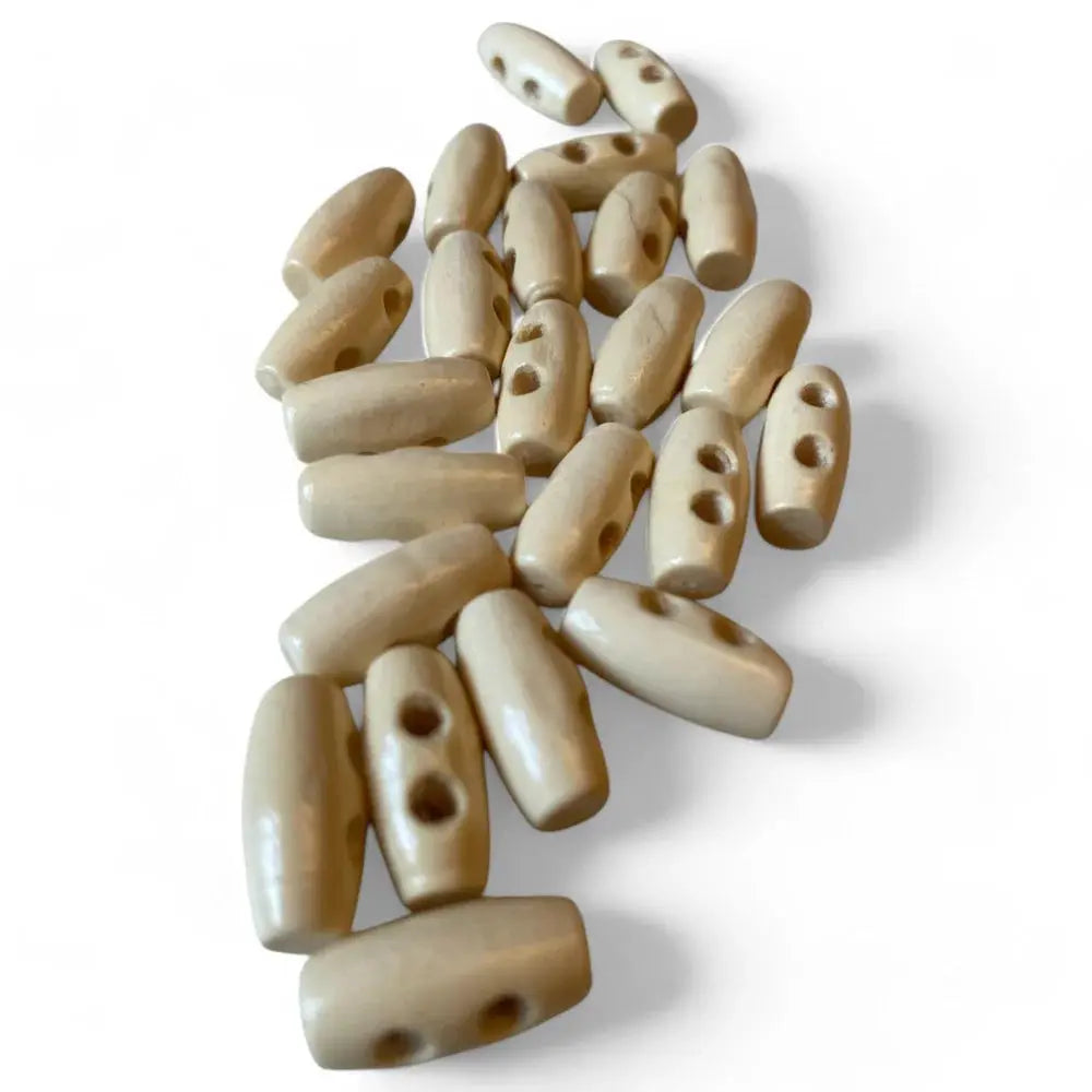 Pile of beige toggle buttons.