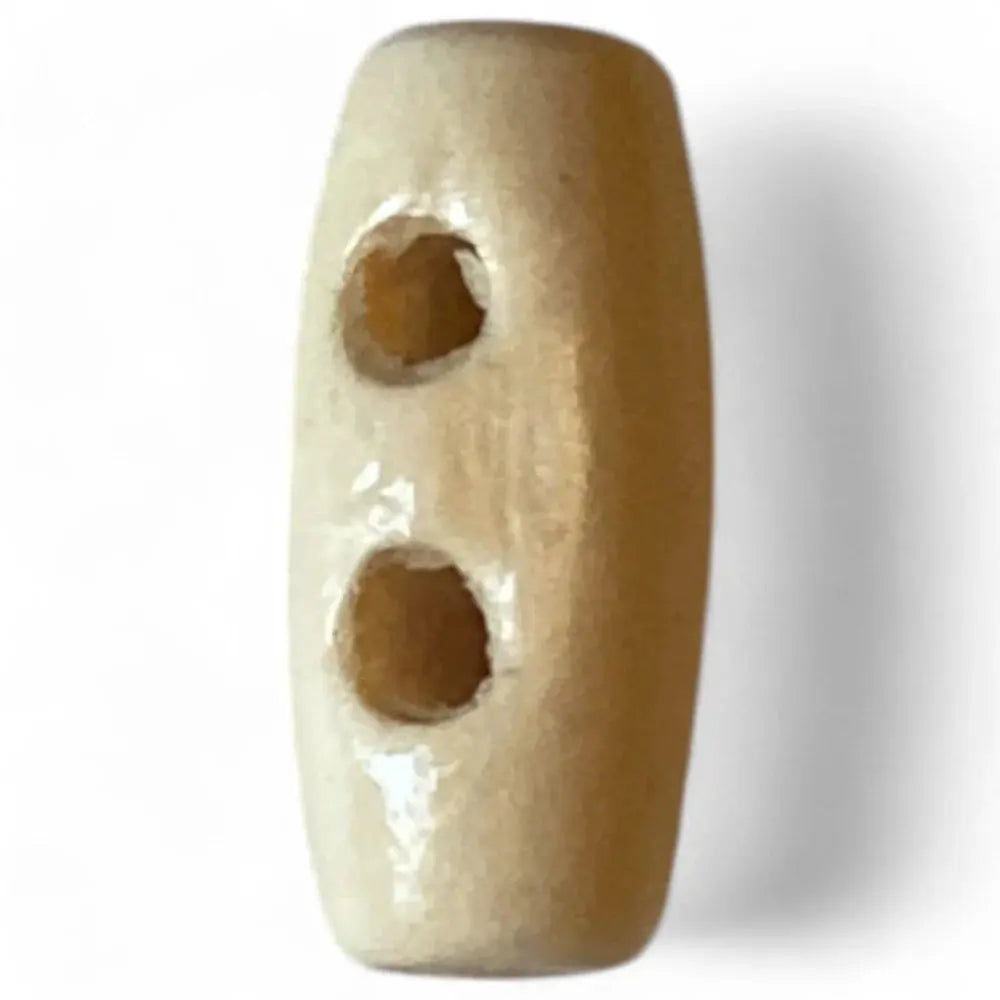 Oblong, two-hole, wooden toggle button.
