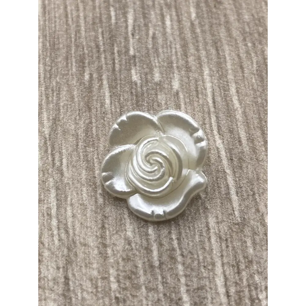 Iridescent white rose embellishment.