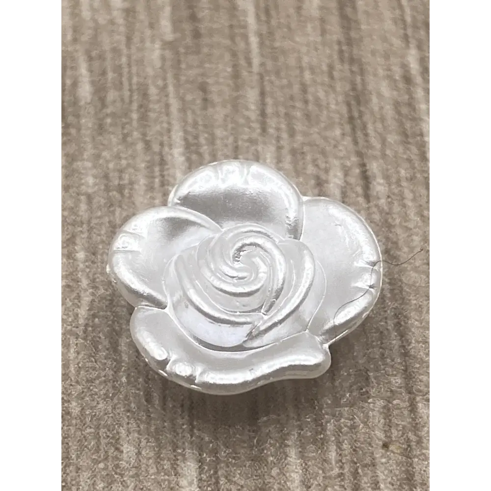 White rose-shaped button.