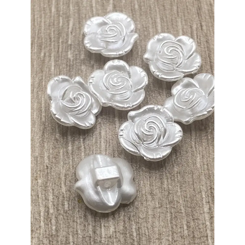 Silver rose-shaped buttons.