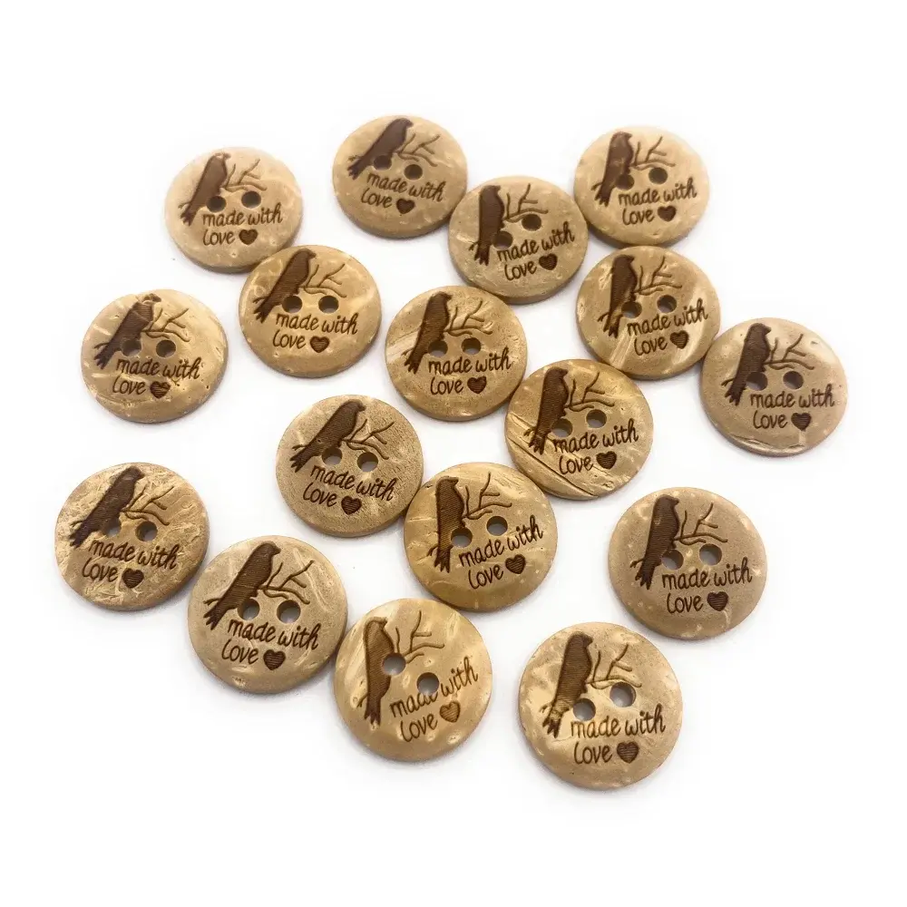 Round, light brown coconut buttons with a bird and ’made with love’ design.