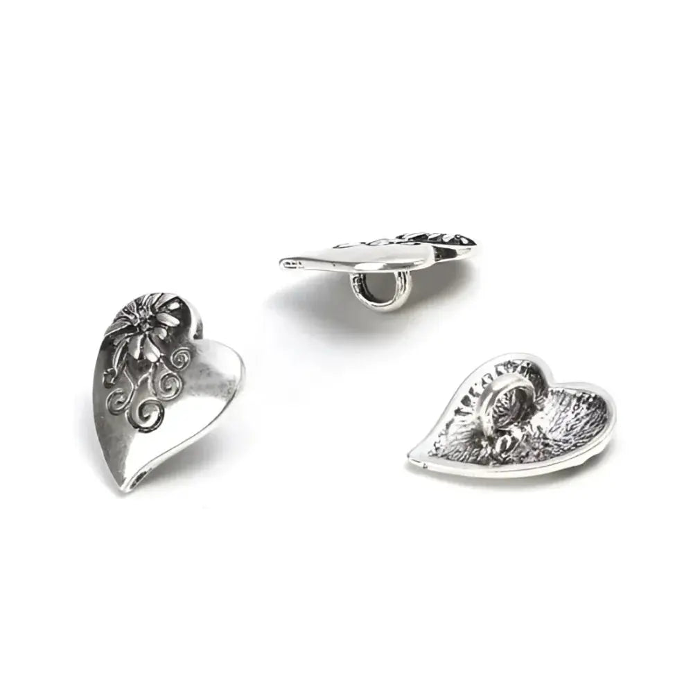 Three silver heart-shaped buttons.