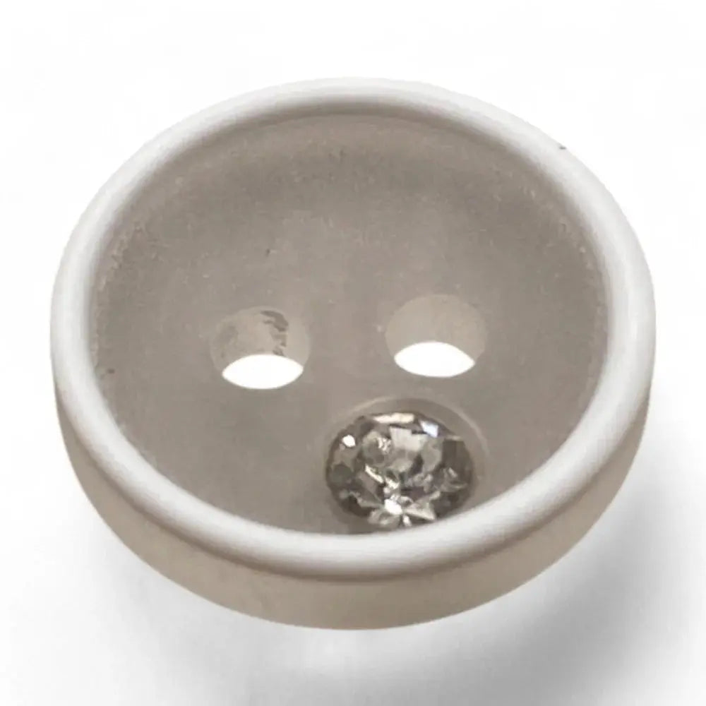 White button with a rhinestone.