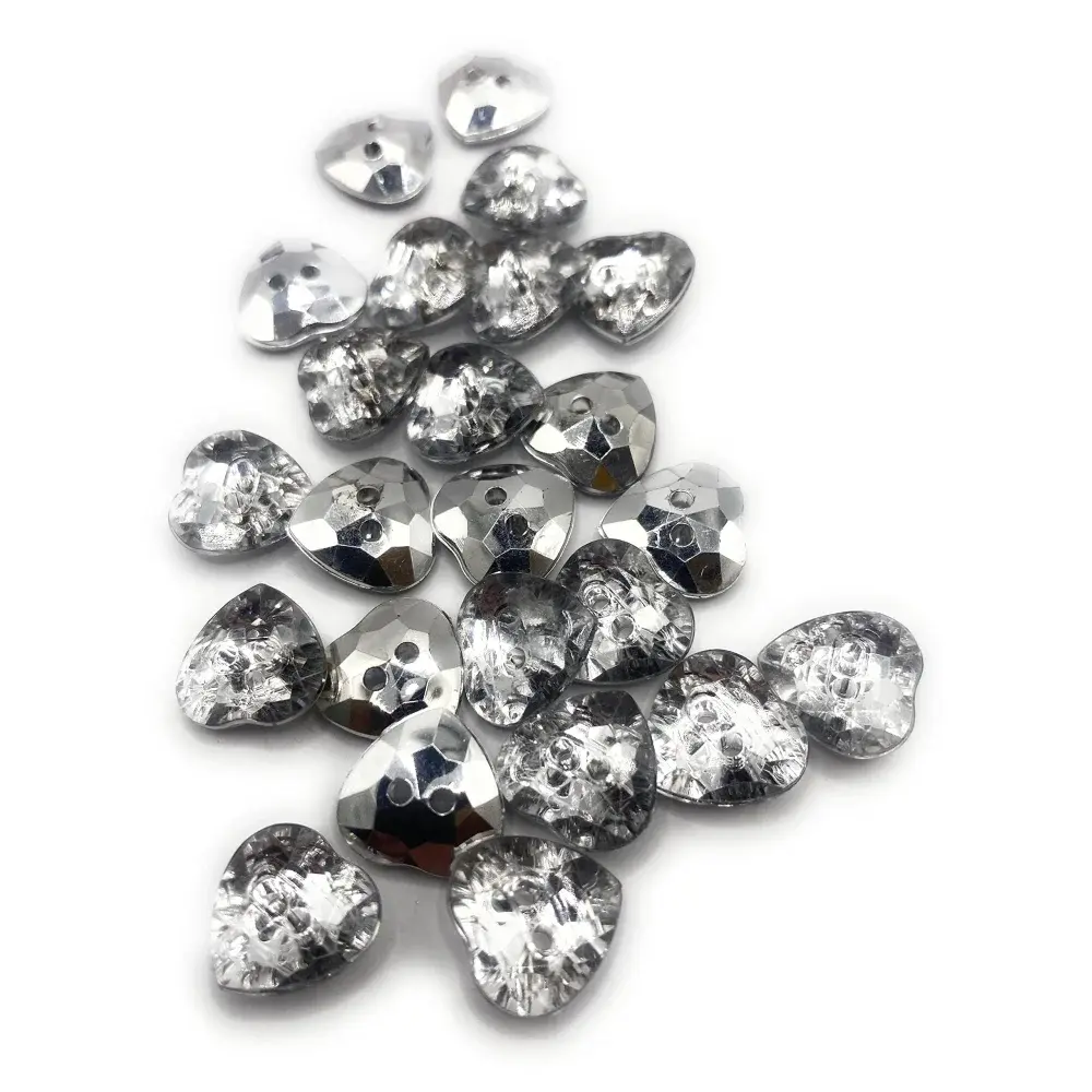 Pile of heart-shaped, faceted, silver buttons.