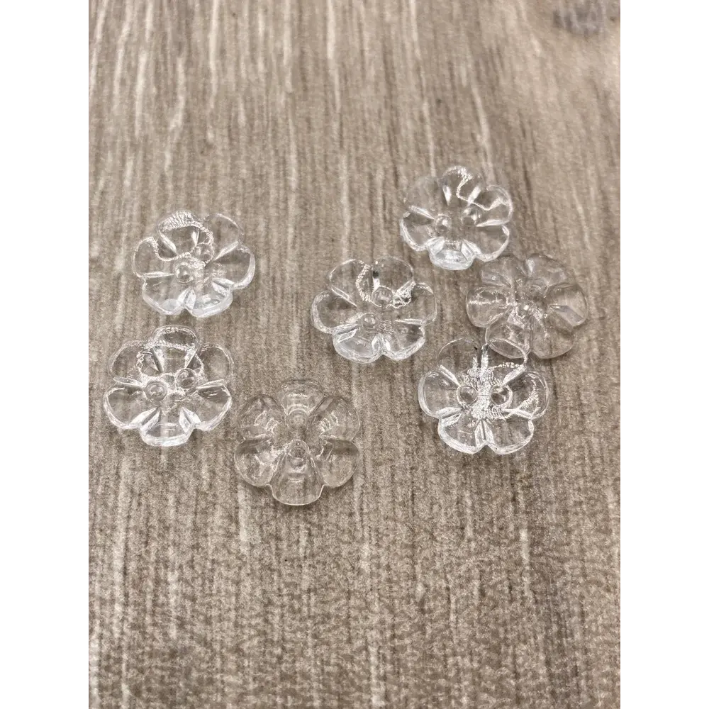 Seven clear flower-shaped buttons.