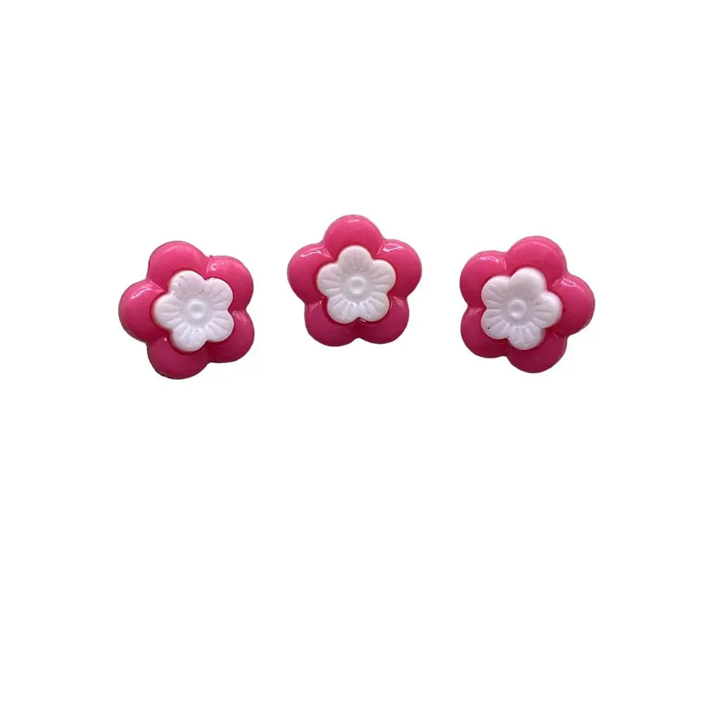 Three pink and white flower buttons.