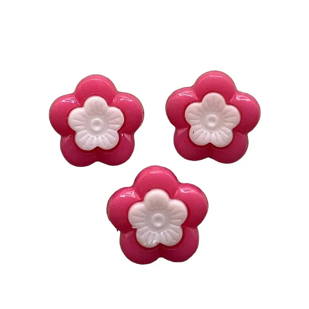 Three pink and white flower buttons.