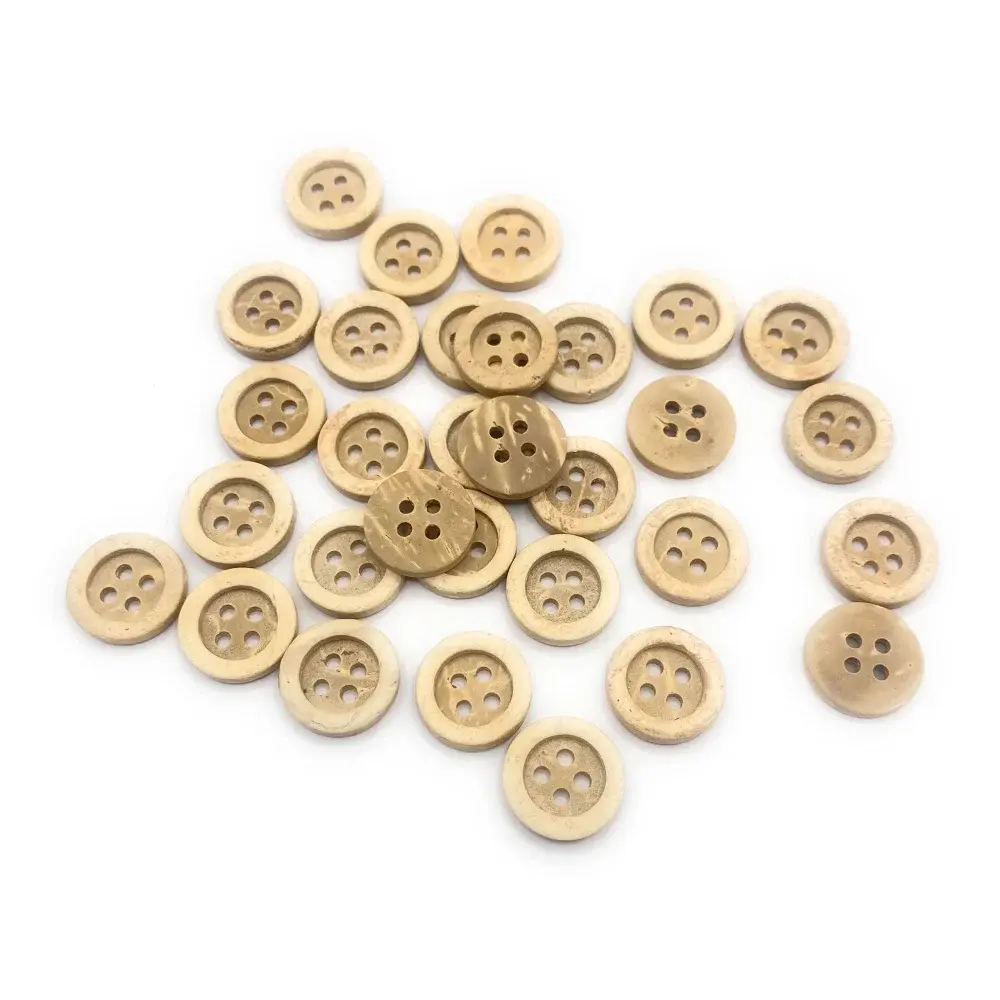 Pile of round wooden buttons.