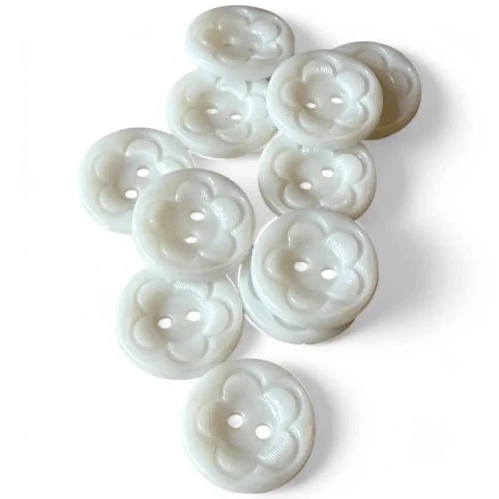 Pile of white flower-shaped buttons.
