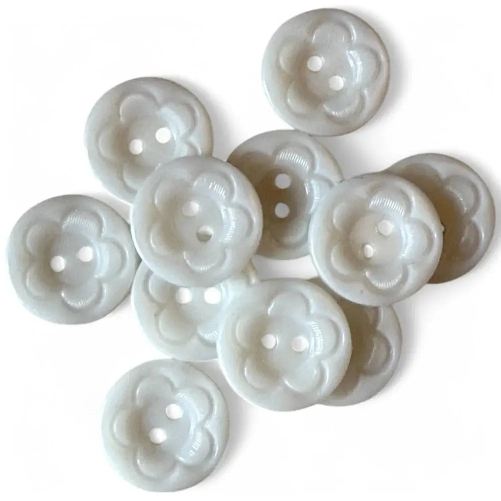 Pile of white flower-shaped buttons.
