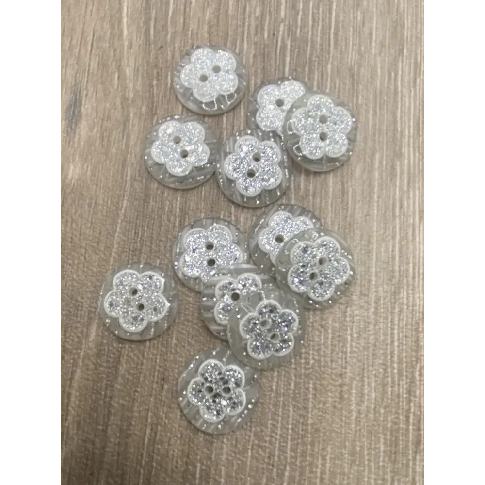 Group of flower-shaped, glittery buttons.