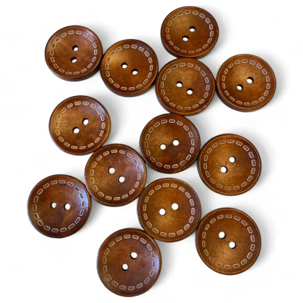 Wooden sewing buttons with decorative stitching.