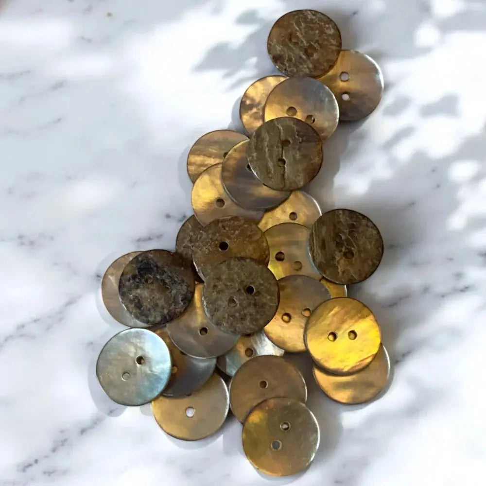 Pile of iridescent, two-holed buttons.