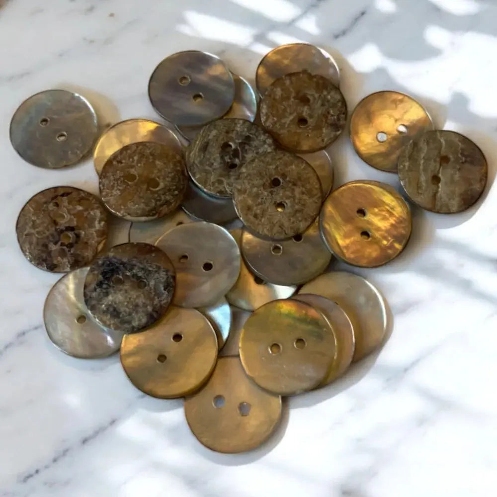 Pile of iridescent, two-holed buttons.