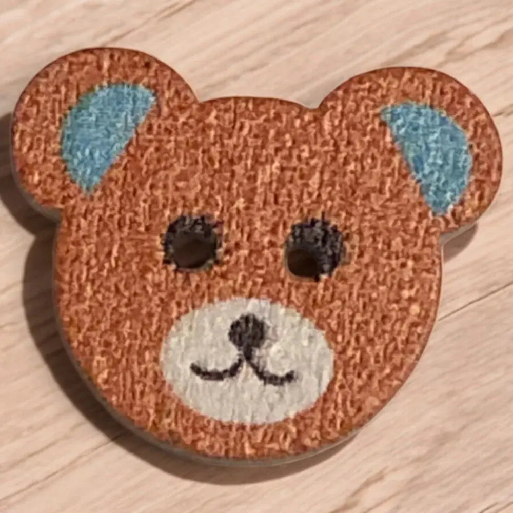 Brown teddy bear button.