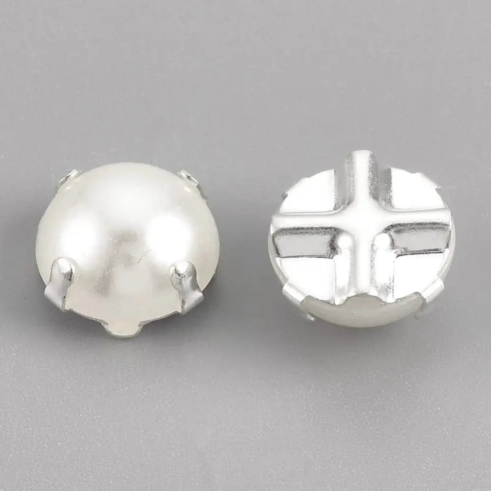 Two white pearl cabochons with silver settings.