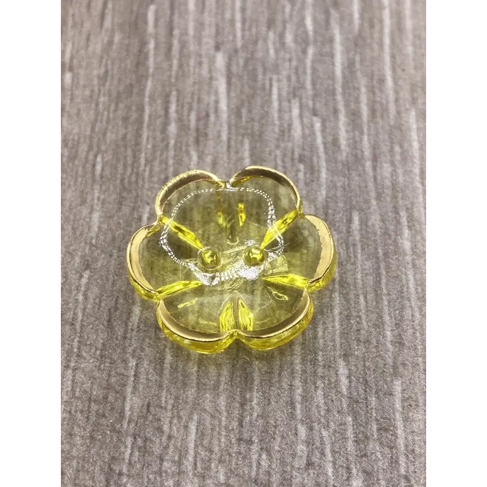 Yellow flower-shaped button.