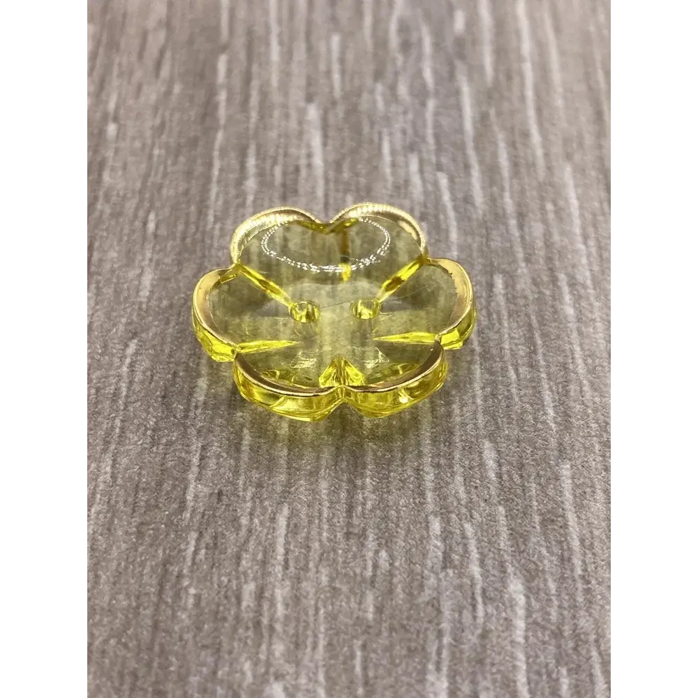 Yellow flower-shaped glass dish.