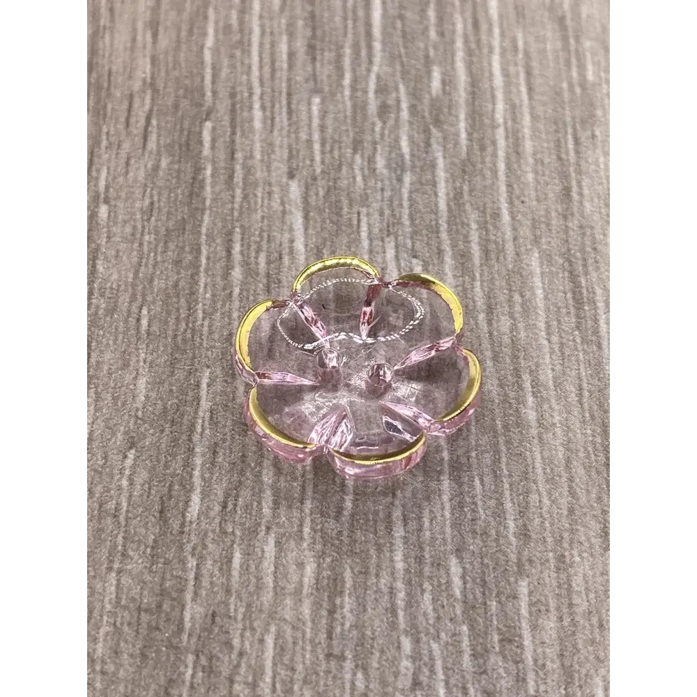 Translucent pink flower with gold trim.